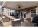 Covered patio with an outdoor ceiling fan and comfortable wicker patio furniture at 15309 Guthrie Dr, Huntersville, NC 28078