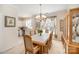 Bright dining area with a chandelier, wood table with chairs, and a china cabinet at 15326 Coventry Court Ln, Charlotte, NC 28277