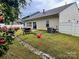 Grassy backyard with patio set, a shade umbrella, and patio perfect for relaxing at 1726 Still River Way, Fort Mill, SC 29708