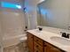 Bathroom featuring a double vanity with wood cabinets and a shower-tub combo at 1726 Still River Way, Fort Mill, SC 29708