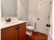Bathroom featuring a single vanity with wood cabinets and hardwood floors at 1726 Still River Way, Fort Mill, SC 29708