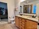 Well-lit bathroom features a double sink vanity with granite countertop and framed mirror at 1726 Still River Way, Fort Mill, SC 29708