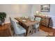 A stylized dining room area with a long wooden table and matching chairs with elegant decor at 1726 Still River Way, Fort Mill, SC 29708