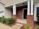 Inviting front porch with brick support columns with direct access to the main entrance of the house at 1726 Still River Way, Fort Mill, SC 29708