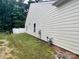 Exterior side view showing neutral siding and a grassy yard adjacent to the home at 1726 Still River Way, Fort Mill, SC 29708