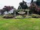 Community entrance sign with well manicured landscaping and flowering trees at 1726 Still River Way, Fort Mill, SC 29708
