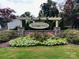 Attractive community entrance sign surrounded by flowering plants and trees at 1726 Still River Way, Fort Mill, SC 29708
