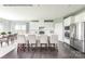 Modern kitchen featuring white cabinets, stainless steel appliances, a central island with barstool seating, and hardwood floors at 1813 Ab Moore Jr Dr # 3239, Indian Trail, NC 28079