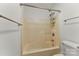 Bathroom with a neutral-colored bathtub and shower combination with white toilet and walls at 200 W 18Th St, Newton, NC 28658