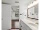 Bathroom view showcasing white cabinets and a sink, with an open doorway to a bedroom at 200 W 18Th St, Newton, NC 28658