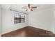 Bedroom featuring a large window, ceiling fan, and hardwood floors at 200 W 18Th St, Newton, NC 28658