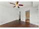 Bedroom showcasing a ceiling fan, hardwood floors, and an ensuite bathroom at 200 W 18Th St, Newton, NC 28658