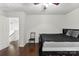 This bedroom features hardwood floors, a chair, a ceiling fan and an open doorway at 200 W 18Th St, Newton, NC 28658
