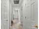 Long hallway with several doors and tile flooring leading to the home's entrance at 200 W 18Th St, Newton, NC 28658