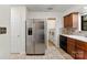 Bright kitchen with stainless steel refrigerator, and a view into the laundry room at 200 W 18Th St, Newton, NC 28658