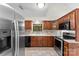 Charming kitchen with wooden cabinets, stainless steel appliances, and a window over the sink at 200 W 18Th St, Newton, NC 28658