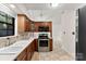 Kitchen featuring stainless steel appliances, wooden cabinets, and tile flooring at 200 W 18Th St, Newton, NC 28658