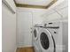 Practical laundry room with modern washer and dryer, wire shelving, and neutral decor at 200 W 18Th St, Newton, NC 28658