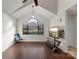 Living room featuring hardwood floors, a large window, vaulted ceilings, and a modern entertainment setup at 200 W 18Th St, Newton, NC 28658