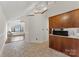 Bright living room with vaulted ceilings, large windows, and tile flooring leading to hardwood floors at 200 W 18Th St, Newton, NC 28658