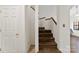 Carpeted staircase with a wooden handrail and a door on the side at 200 W 18Th St, Newton, NC 28658