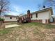 Backyard featuring a wood deck, a detached garage, and partial grass cover at 206 Colonial Cir, Wingate, NC 28174