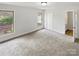 Bright bedroom featuring carpet, natural light, and access to an ensuite bathroom at 206 Colonial Cir, Wingate, NC 28174