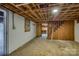 Unfinished basement space featuring concrete floors, exposed beams, and access to other rooms at 2625 20Th Ne St, Hickory, NC 28601