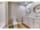 Bathroom featuring double sinks, new white vanity with marble countertop, and wood-look flooring at 2625 20Th Ne St, Hickory, NC 28601