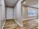 Hallway with laminate wood floors, neutral paint, and white doors and trim at 2625 20Th Ne St, Hickory, NC 28601