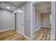 Hallway with neutral paint, laminate flooring, and white doors and trim at 2625 20Th Ne St, Hickory, NC 28601