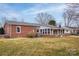 Brick home featuring a screened porch, brick accents, and a well-maintained lawn for outdoor enjoyment at 2625 20Th Ne St, Hickory, NC 28601