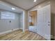 This room features wood-look flooring, with a white door leading to an unfinished room at 2625 20Th Ne St, Hickory, NC 28601