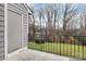 A balcony with railings overlooking a backyard with lush greenery and mature trees at 2900 Heathstead Pl # H, Charlotte, NC 28210