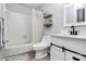 Bright bathroom featuring a white vanity, toilet, bathtub with decorative curtain, and floating shelves at 2900 Heathstead Pl # H, Charlotte, NC 28210