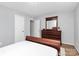 Cozy bedroom features a wood dresser, neutral walls, and ample closet space at 2900 Heathstead Pl # H, Charlotte, NC 28210