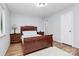 Comfortable bedroom with a wood bed, matching nightstands, and soft carpeting at 2900 Heathstead Pl # H, Charlotte, NC 28210