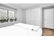 Bright bedroom with a large window, closet, and fresh white linens on the bed at 2900 Heathstead Pl # H, Charlotte, NC 28210