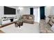 Spacious living room featuring a plush sectional sofa, modern entertainment center, and bright natural light at 2900 Heathstead Pl # H, Charlotte, NC 28210