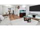 Bright living room featuring hardwood floors, a modern entertainment center, and an eye-catching fish tank at 2900 Heathstead Pl # H, Charlotte, NC 28210