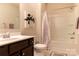 Neutral bathroom with dark vanity, tile floors, and a shower and tub combination at 3156 Pinehills Way, Mount Holly, NC 28120