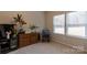 Light-filled bedroom featuring a large window, dresser, and cozy seating area at 3156 Pinehills Way, Mount Holly, NC 28120