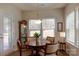 Bright dining area next to a large window with table and four chairs at 3156 Pinehills Way, Mount Holly, NC 28120