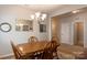 Dining room with wood table, chairs, and adjacent hallway and doorway at 3156 Pinehills Way, Mount Holly, NC 28120