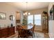 Cozy dining room features a wooden table set, a large window, and traditional furnishings at 3156 Pinehills Way, Mount Holly, NC 28120