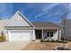 Charming single-story home with a two-car garage, manicured lawn and inviting front porch at 3156 Pinehills Way, Mount Holly, NC 28120