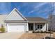 Charming single-story home with a well-maintained front yard and an attached two-car garage at 3156 Pinehills Way, Mount Holly, NC 28120