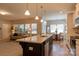 Open concept, large kitchen island sink and dishwasher, view of living and dining areas at 3156 Pinehills Way, Mount Holly, NC 28120