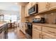 Well-lit kitchen with white cabinetry, stainless steel appliances, and hardwood flooring at 3156 Pinehills Way, Mount Holly, NC 28120