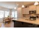 Open layout combining kitchen with breakfast nook featuring many windows and natural light at 3156 Pinehills Way, Mount Holly, NC 28120